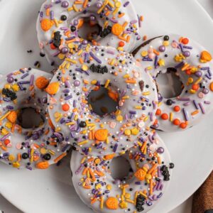 Halloween donuts on a white plate.