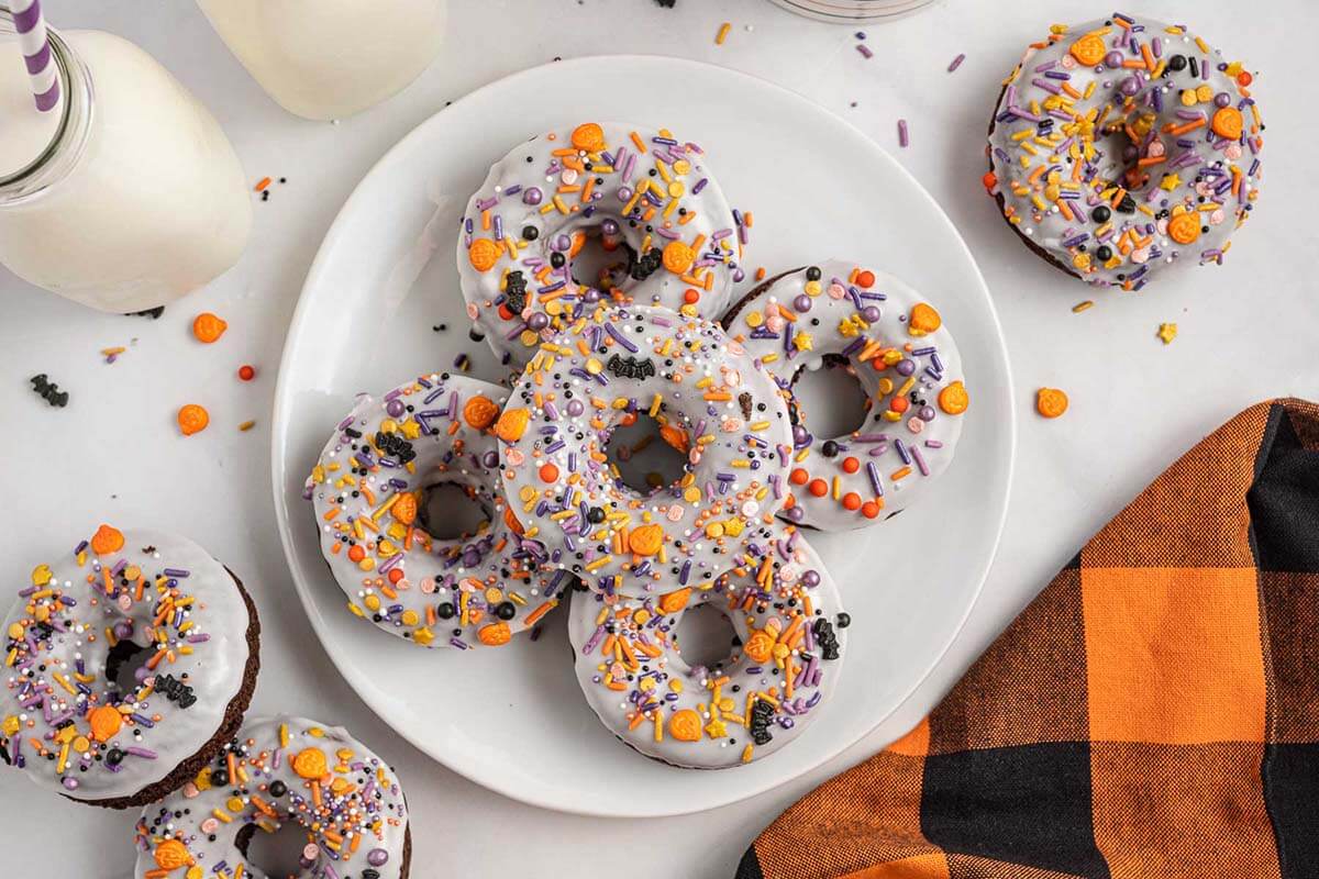 A plate of decorated Halloween donuts. 