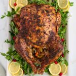 Roast turkey on a white platter.