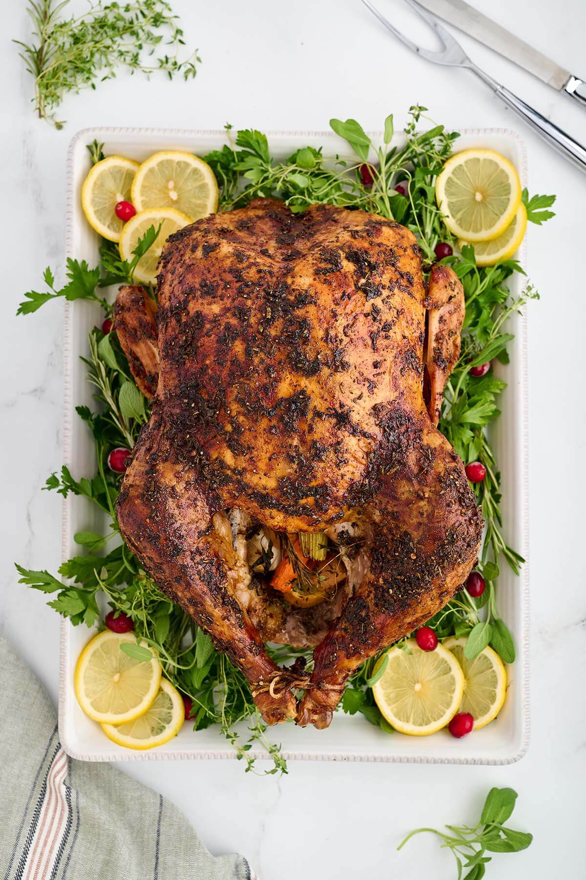 Roast turkey on a white platter.