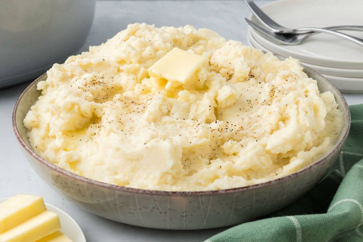 Bowl of mashed potatoes with fork.