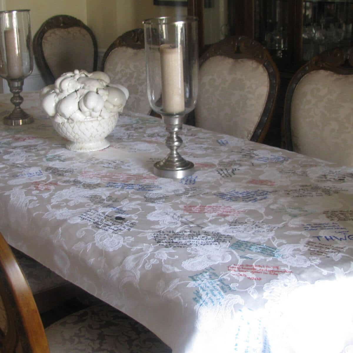 Dining room table covered with a tablecloth.