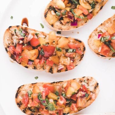 Pieces of bread topped with bruschetta.