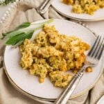 Cornbread dressing on a plate with a fork.