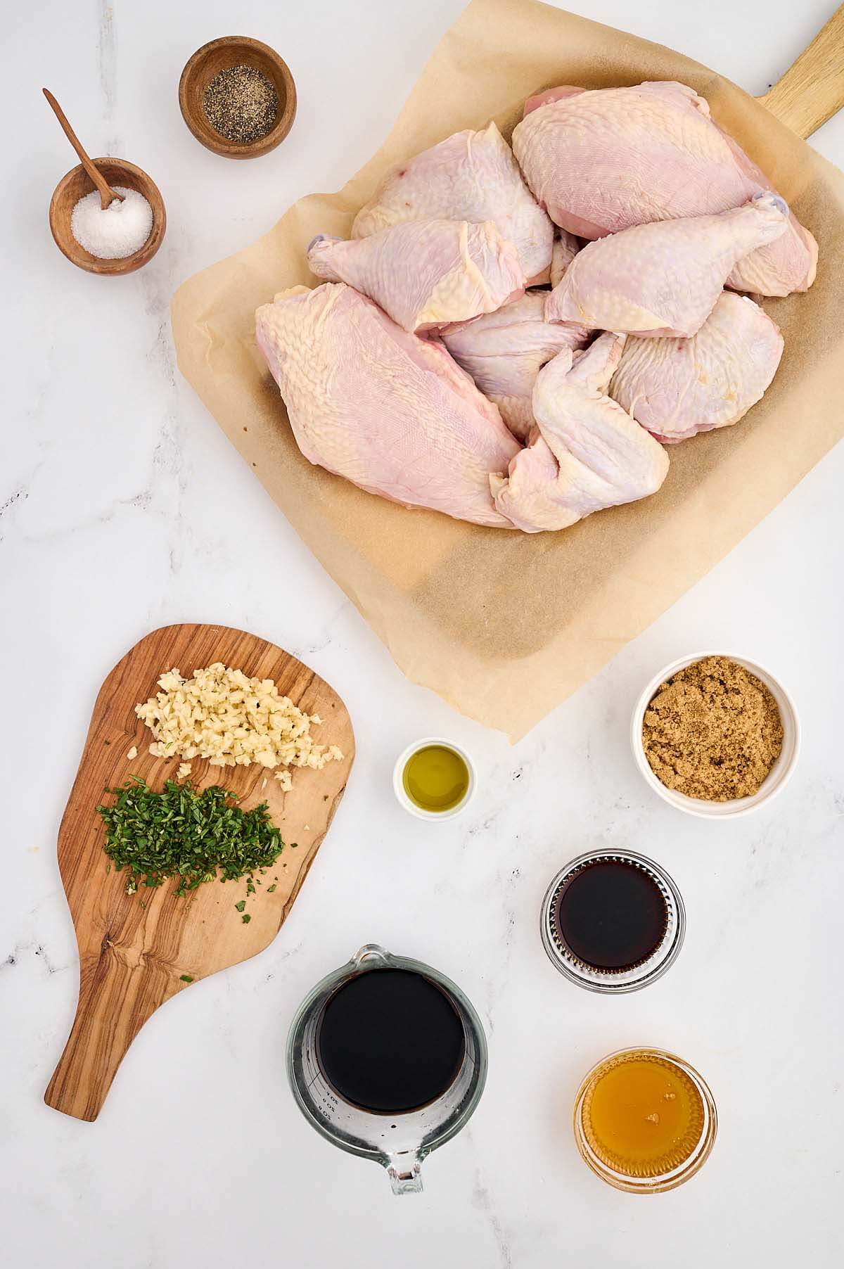 Chicken and herbs on a cutting board.