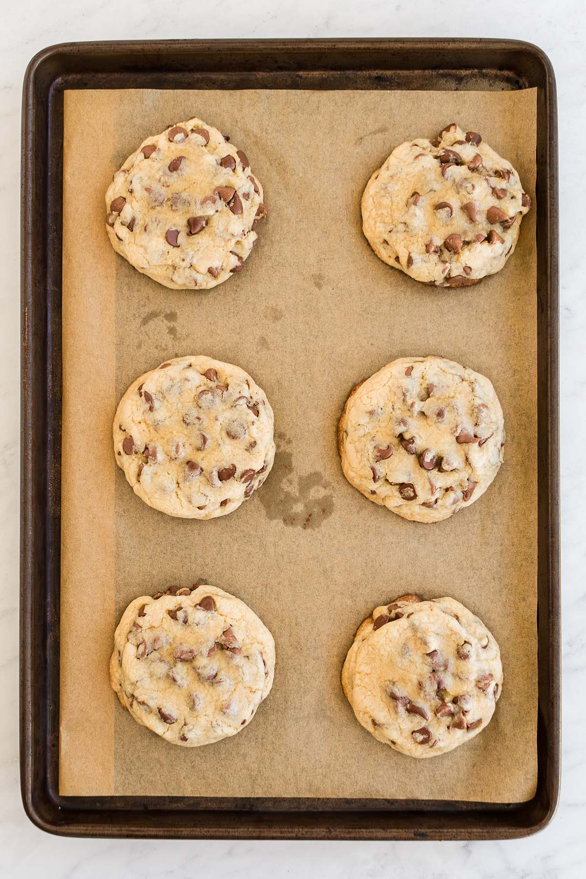 Six cookies on a baking sheet
