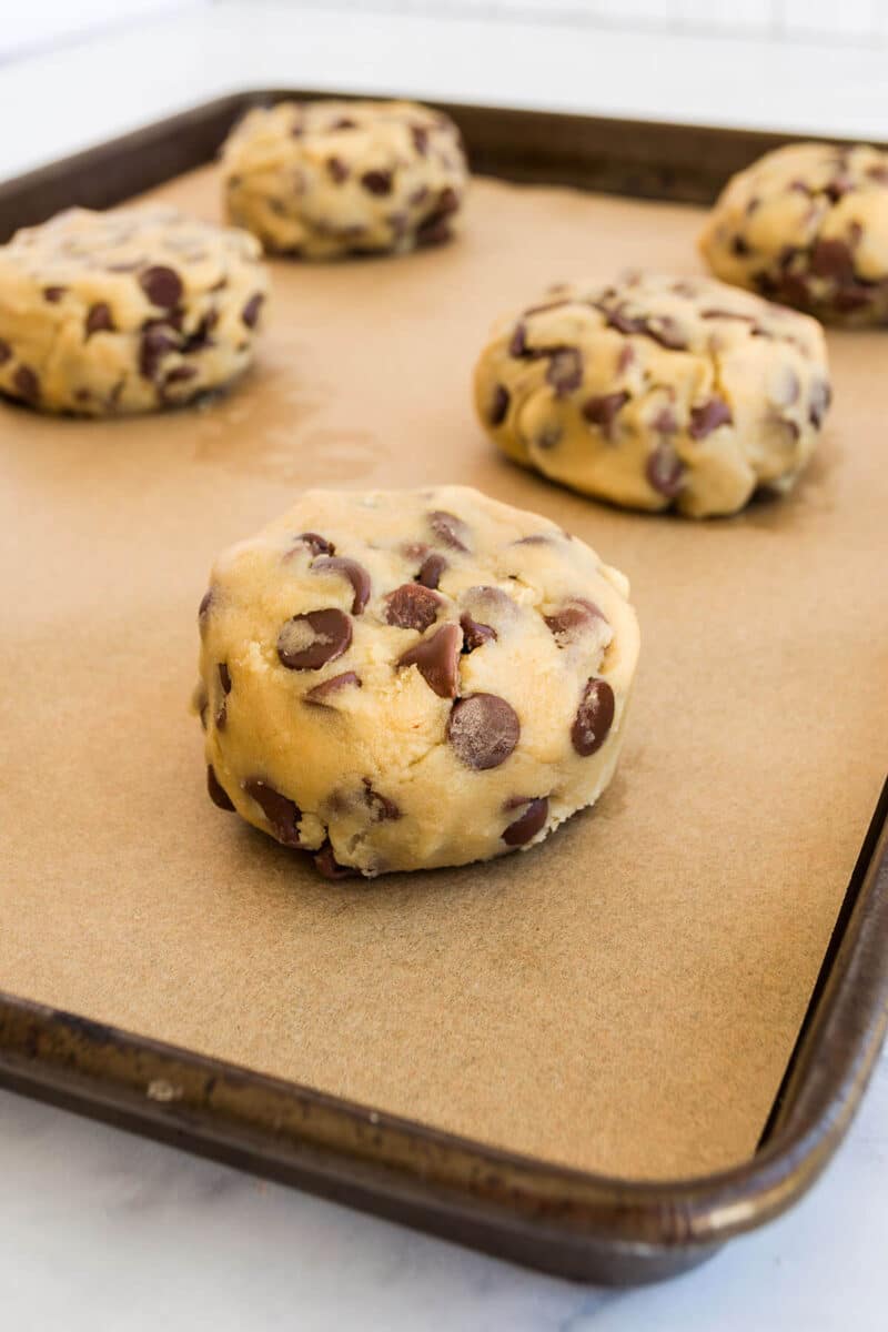 Round balls of cookie dough on parchment paper