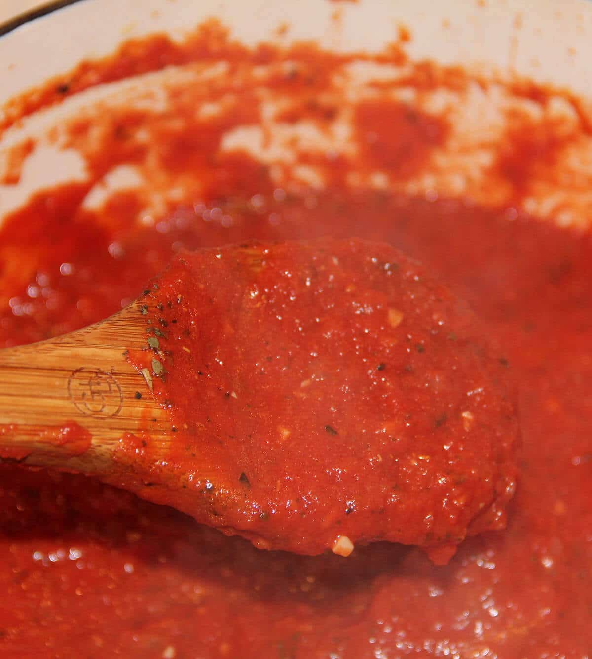 A pot with marinara sauce with crushed tomatoes