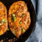 Green onions garnishing a chicken breast.
