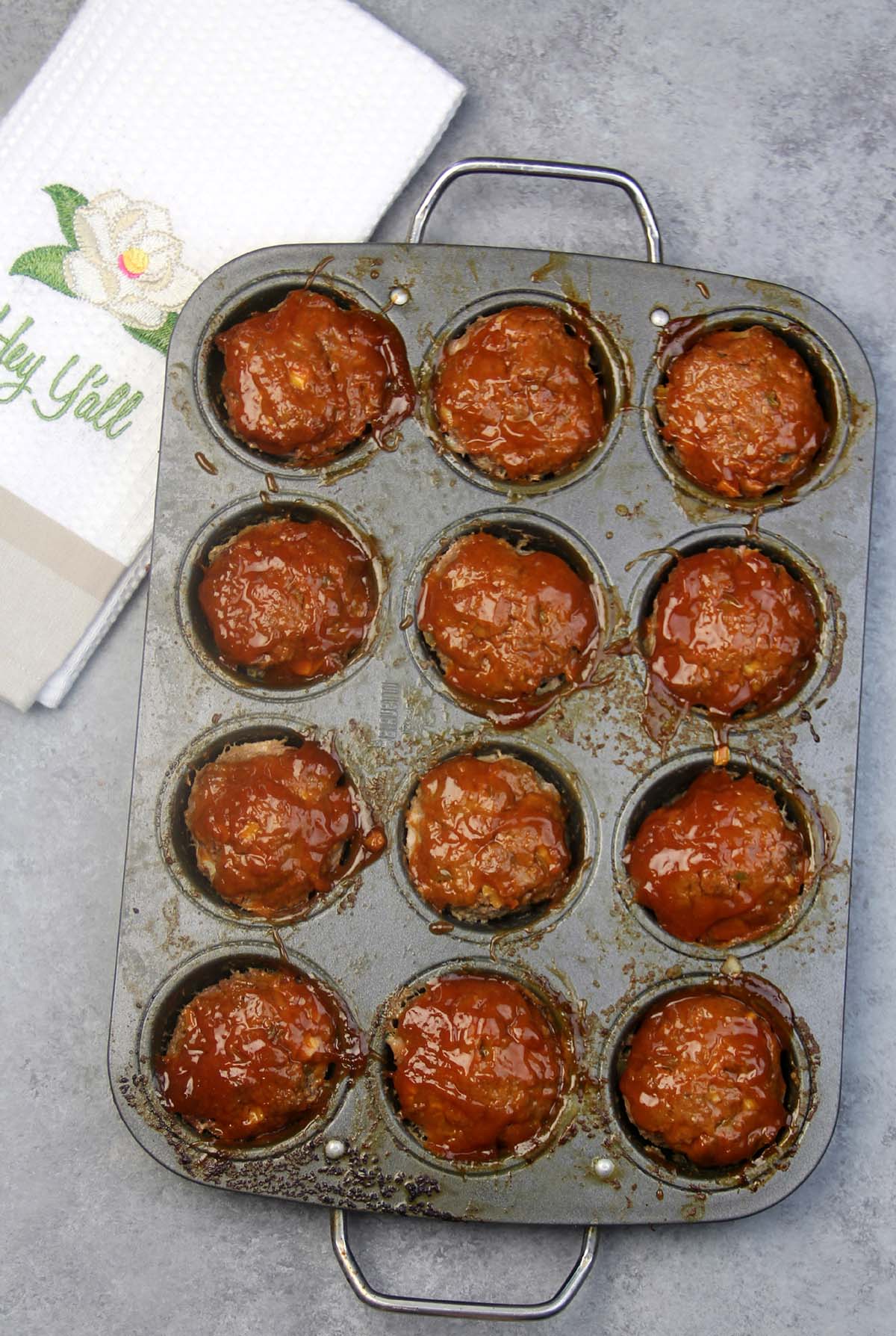 A muffin pan with baked meatloaf.