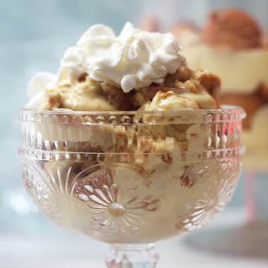A bowl of Southern banana pudding topped with homemade whipped cream.