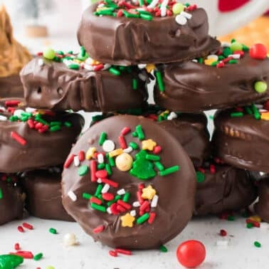 Stack of Chocolate-covered Ritz crackers topped with colorful holiday sprinkles.