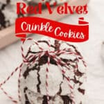 Stack of red velvet crinkle cookies tied with a red and white string, with festive lights and text reading "Red Velvet Crinkle Cookies.