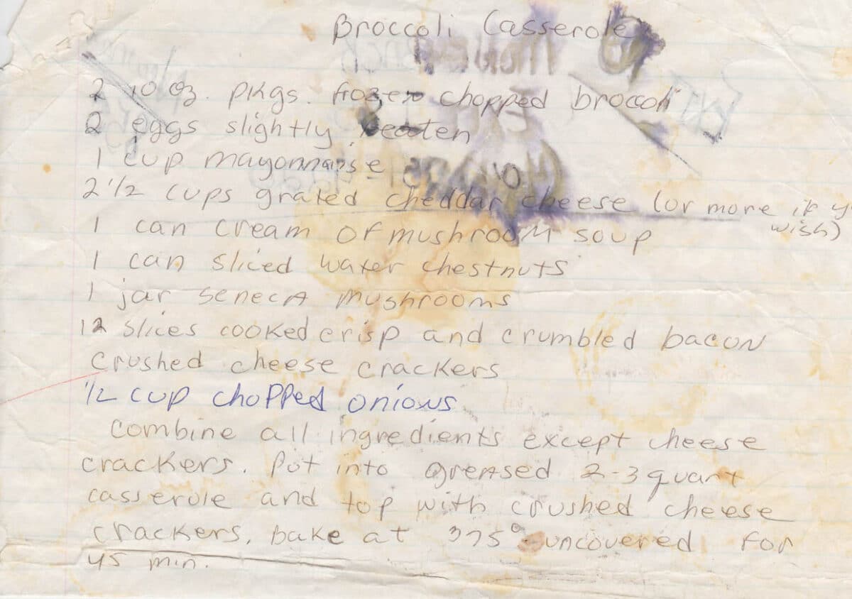 A handwritten broccoli casserole recipe with ingredients like broccoli, eggs, mayonnaise, cheese, soup, chestnuts, mushrooms, bacon, and onions. Instructions for cooking are included.