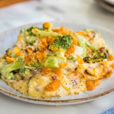 A plate of broccoli and cheese casserole with a crispy topping, served on a white plate.