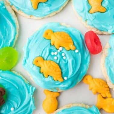 Cookies with blue icing topped with colorful animal-shaped crackers and jelly candies.