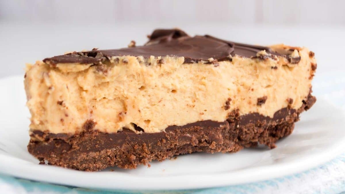 A slice of chocolate peanut butter pie on a white plate.