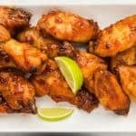 A plate of glazed chicken wings garnished with lime wedges, with text reading "17 Wing Recipes" at the top and "southernfoodandfun.com" at the bottom.