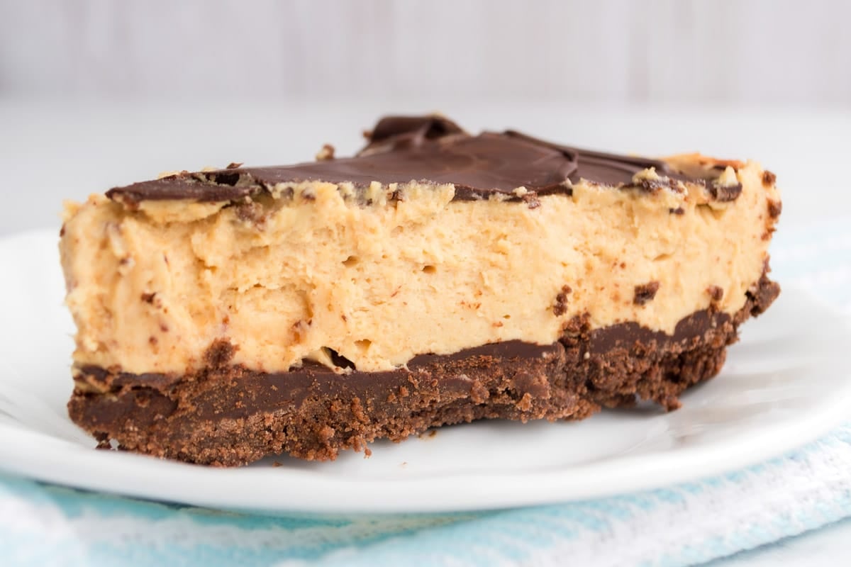 A slice of chocolate peanut butter pie on a white plate. 