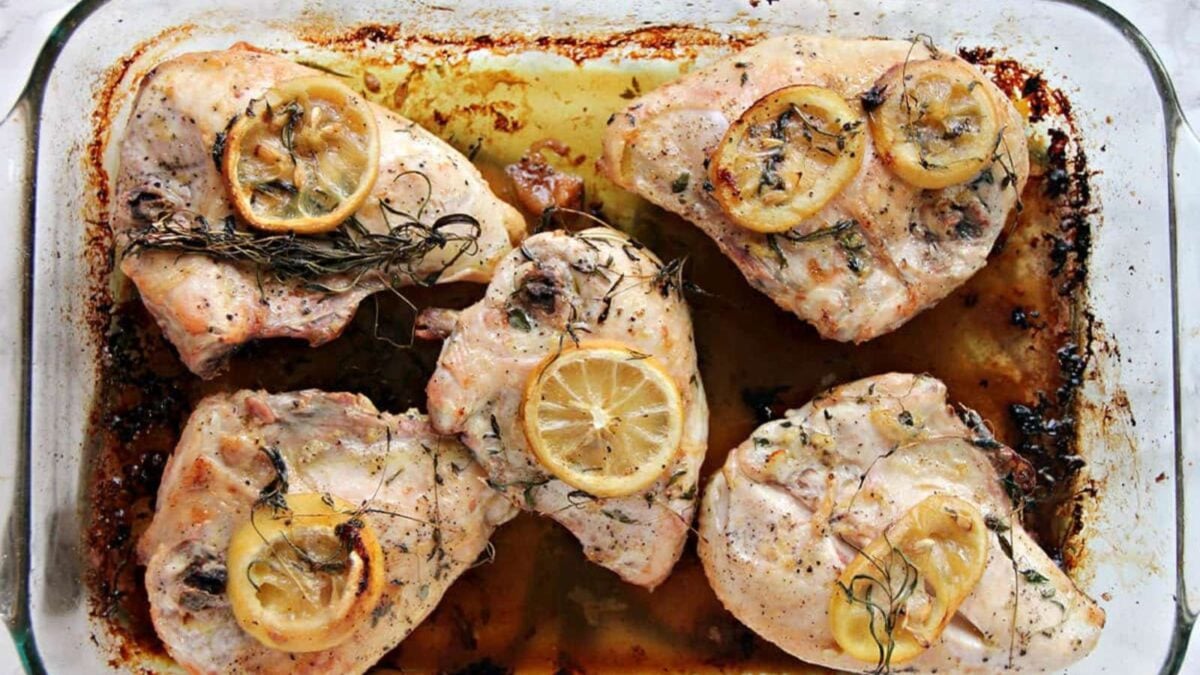 A loaf of homemade banana bread, sliced on a wooden board, is paired with bananas, a striped cloth, and a plate of butter—perfect inspiration for your next unique bread recipe.