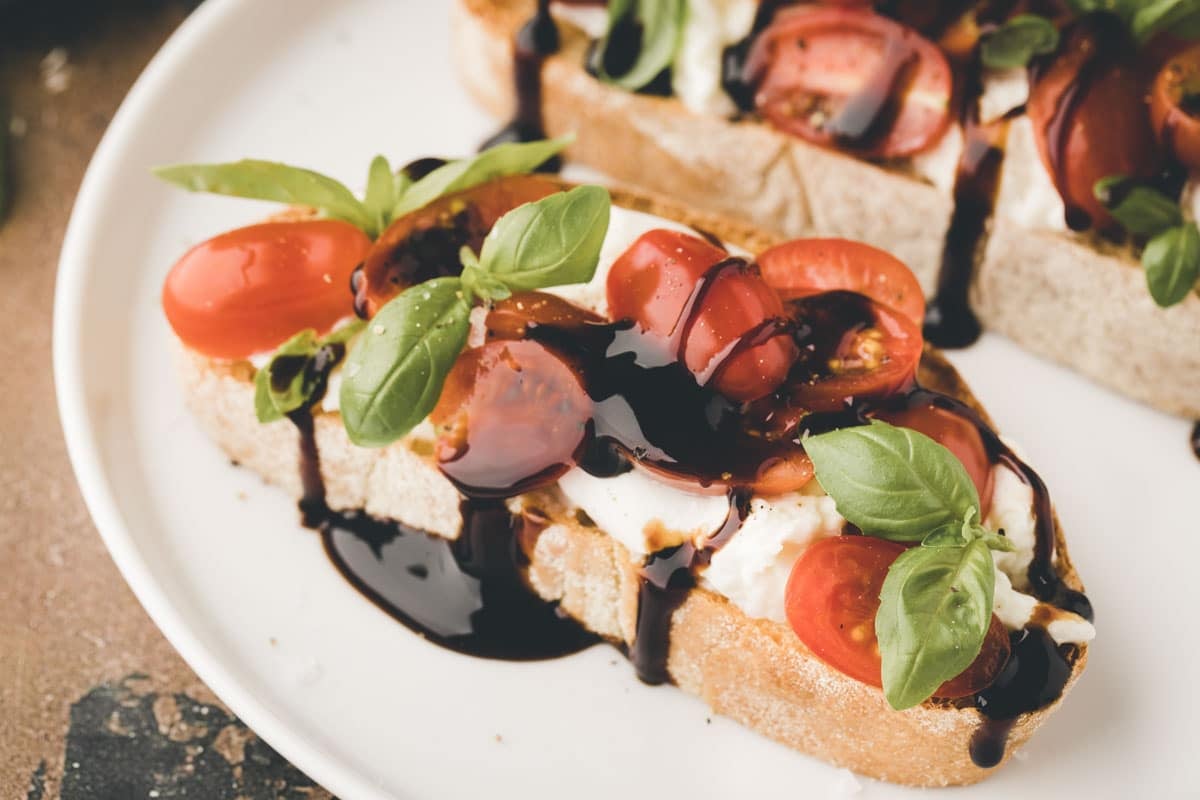 Crispy ciabatta with garlic butter, mozzarella, tomatoes, basil, and balsamic glaze 