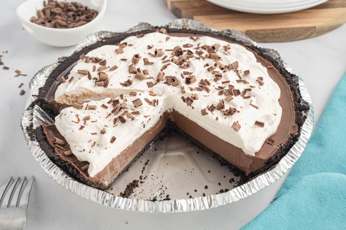 A rich, creamy no-bake chocolate pie with an Oreo crust and fluffy whipped topping—perfect