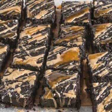 Rectangular espresso brownies arranged in rows, topped with a light brown and caramel drizzle.