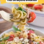 A fork holds a bite of pasta with bacon, spinach, and tomato over a bowl. Text reads: "20 Bacon Recipes That Go Beyond Breakfast.