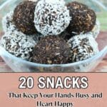 A glass bowl filled with chocolate and coconut-covered snack balls, with text overlay: "20 Snacks That Keep Your Hands Busy and Heart Happy.