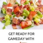 A plate of BLT dip topped with lettuce, tomato, bacon, and tortilla chips is served on a white plate, accompanied by promotional text for the dip.