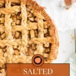 Overhead view of a salted caramel apple pie with a braided lattice crust, a small bowl of caramel sauce, and a green-patterned napkin on the side.
