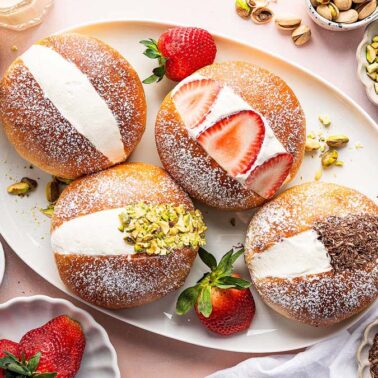 A plate of pastries with strawberries and pistachios—perfect for make ahead breakfasts or breakfast meal prep.
