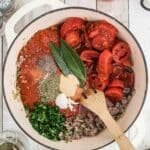 A pot of food with a wooden spoon.