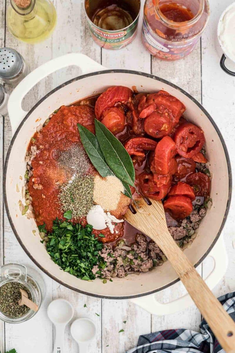 A pot of food with a wooden spoon.