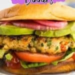 A turkey burger with lettuce, tomato, avocado, and onions on a bun, with text that reads "12 Turkey Dinners.