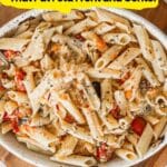 A serving dish filled with baked penne pasta mixed with feta cheese, cherry tomatoes, and herbs, viewed from above. Text overlay promotes feta-focused pasta dishes.