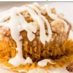 A pumpkin muffin with streusel topping and white icing sits on a plate. Text above reads "14 Pumpkin Recipes That Make Mornings Better.