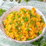 A bowl of cheesy rice topped with chopped green onions sits on a green striped cloth, with text reading "18 Easy Dinners"โperfect for anyone looking for quick dinner recipes.