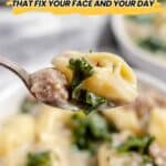 A close-up of a spoonful of soup with tortellini, sausage, and greens, with bowls of soup in the background and text reading "21 Comfort Soups That Fix Your Face and Your Day.
