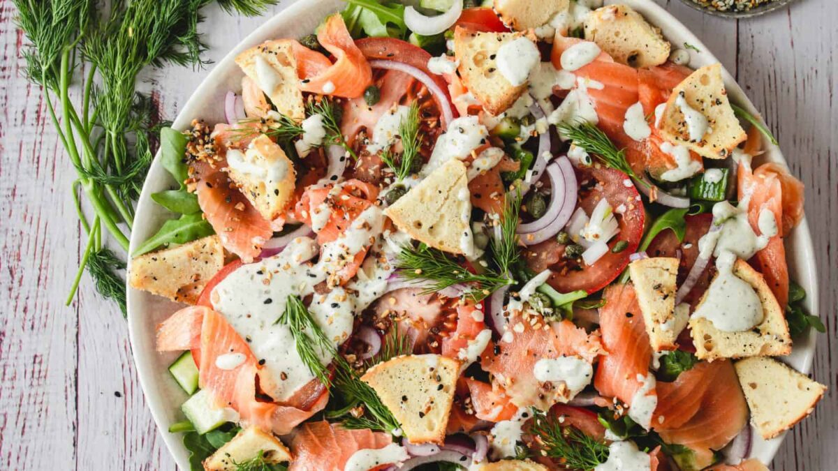A plate of salad with fish and vegetables, bringing together fresh ocean flavors for a light and refreshing seafood dish.