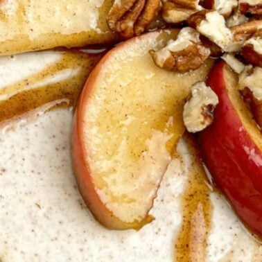 Close-up of a dessert topped with apple slices, chopped pecans, and a drizzle of syrup—perfect for those who love easy cooking and quick meals.