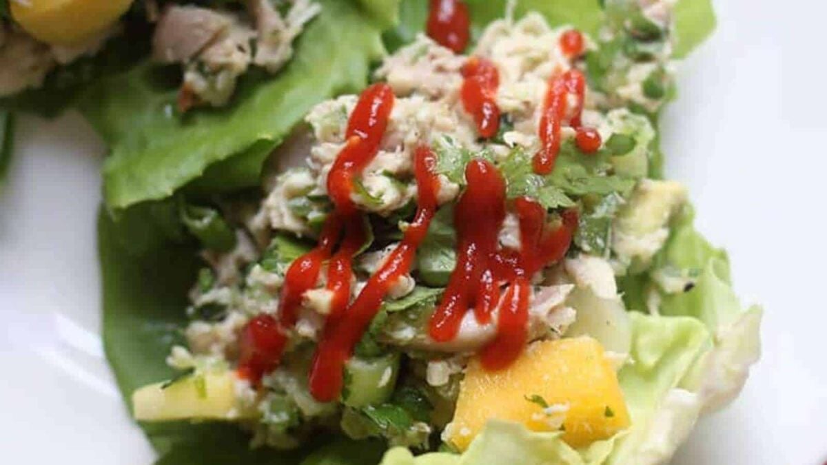 A lettuce leaf filled with a chopped salad mixture and topped with sriracha sauce—one of the best healthy lunches for easy meal ideas.
