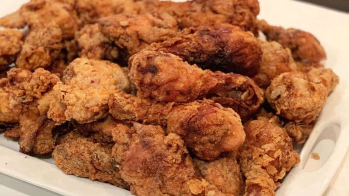 A plate filled with crispy, golden-brown fried chicken pieces arranged on a white rectangular dish—perfect for satisfying meals or indulgent lunches.