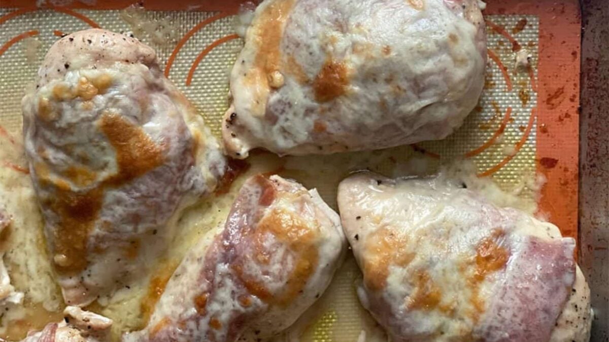 Five pieces of baked chicken breast covered with melted cheese on a silicone baking mat—perfect for easy dinner recipes and simple dinners.