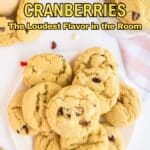 A plate of cranberry cookies on a white surface with the text "11 Ways to Make Cranberries: The Loudest Flavor in the Room.