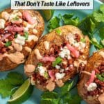 Three baked potatoes topped with crumbled cheese, seasoned meat, sauce, and pickled onions are garnished with cilantro and lime wedges on a blue plate.