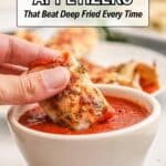A hand dips an air-fried appetizer into a bowl of marinara sauce, with more appetizers on a plate in the background.