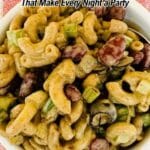 Bowl of macaroni salad with kidney beans, celery, and green onions on a red checkered cloth, with text overlay about Mexican recipes.