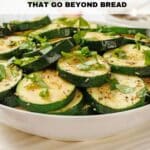 A bowl of cooked zucchini slices garnished with fresh herbs, with text reading "13 Zucchini Recipes That Go Beyond Bread" and "Southern food and fun" at the bottom.