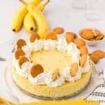 A cheesecake topped with whipped cream and vanilla wafers sits on a table with bananas and more vanilla wafers in the background. Text reads: "14 Creamy Pudding Recipes That Don’t Come from a Box.